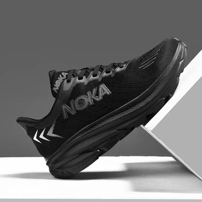 Black running shoe with 'Noka' branding on a gray background
