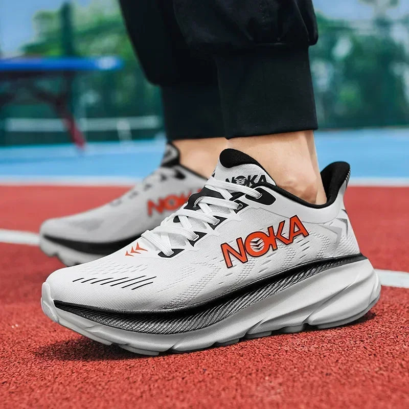White running shoes with 'Noka' branding on a red track
