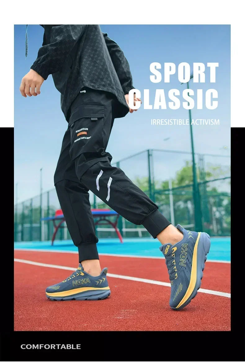 Person wearing black athletic pants and blue shoes on a sports field with 'Sport Classic' text.